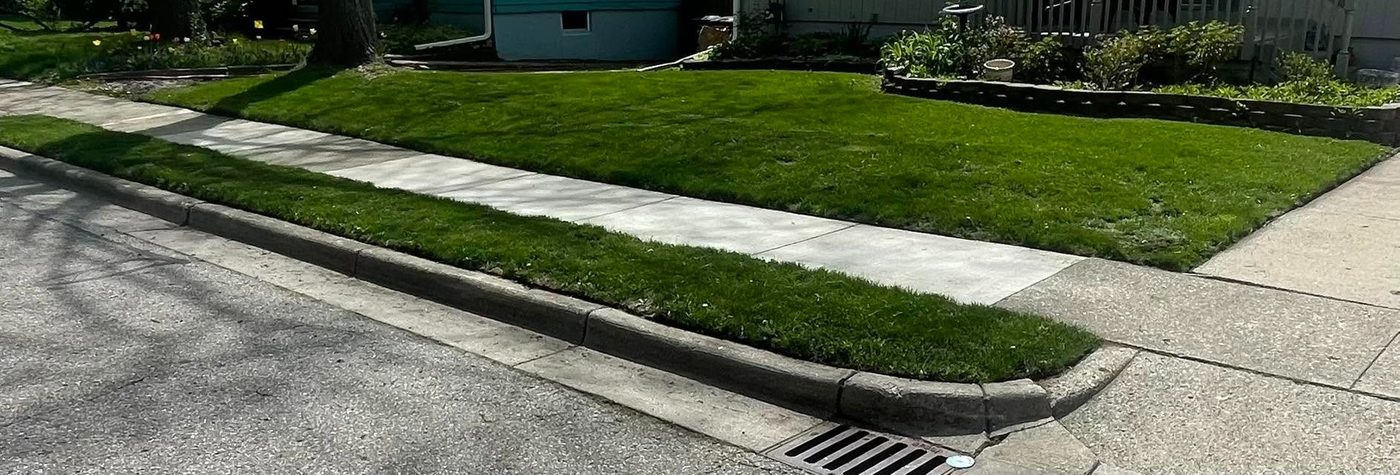 Crisp edging along a sidewalk in Clinton, Michigan